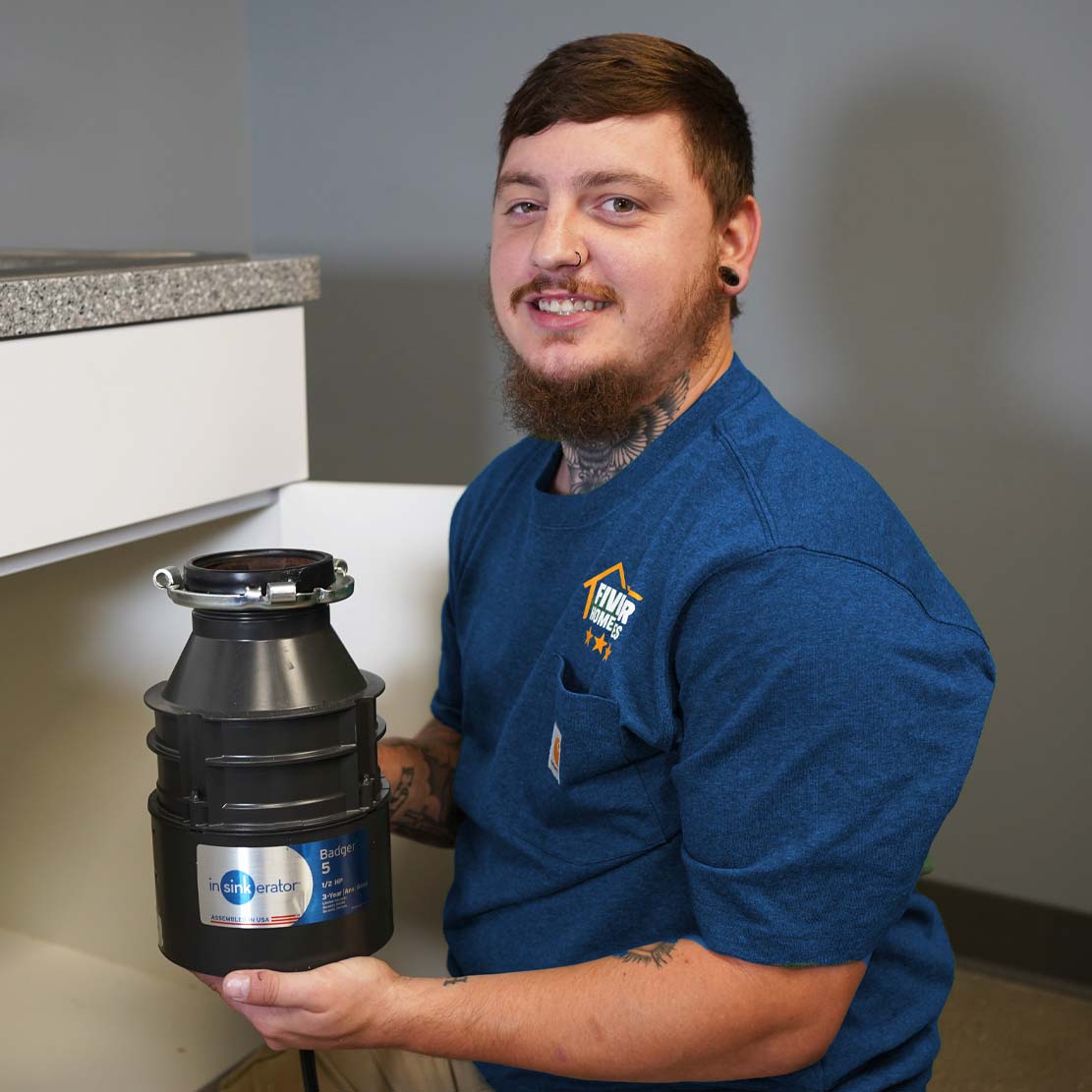 Plumber Holding a Garbage Disposal