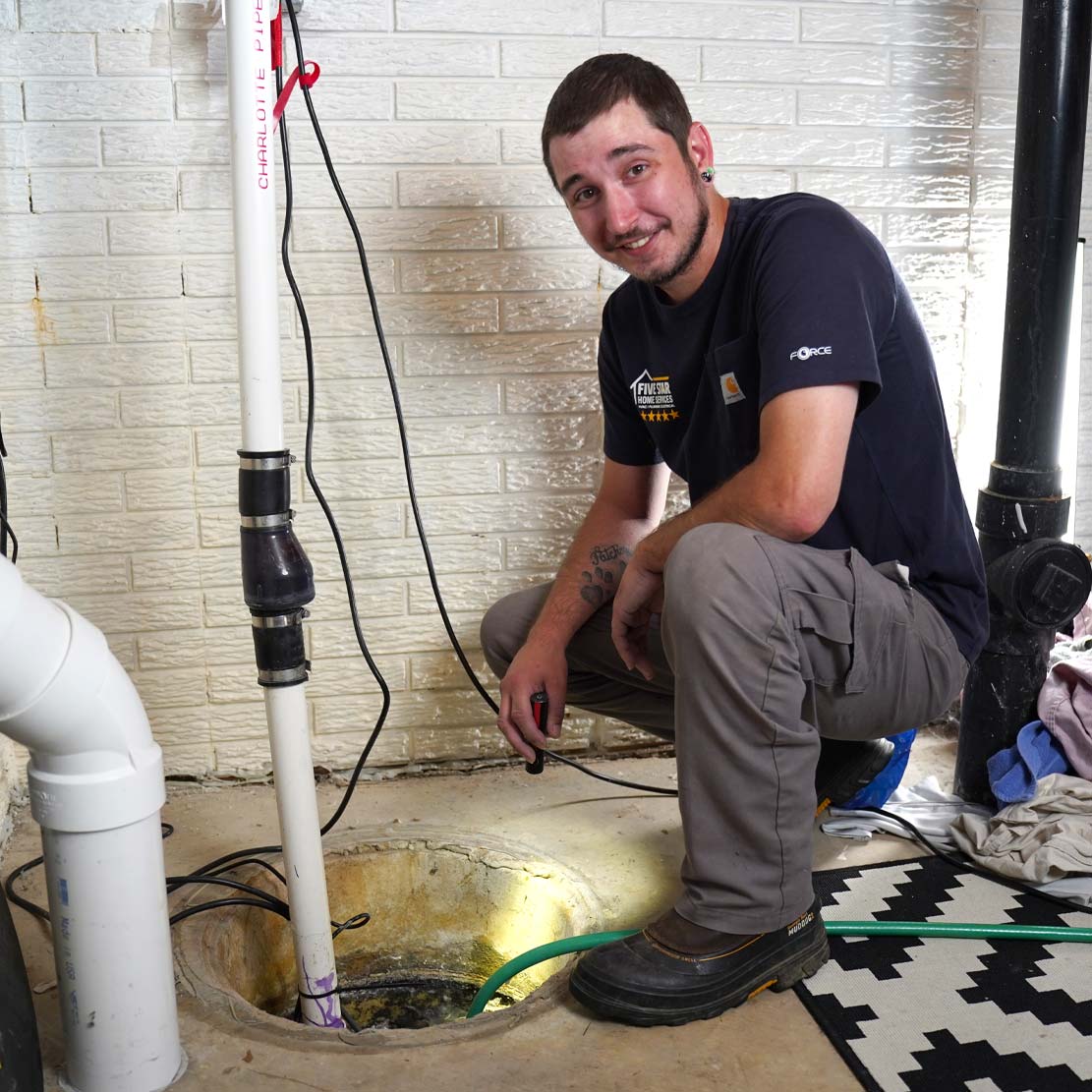 Plumber fixing a sump pump