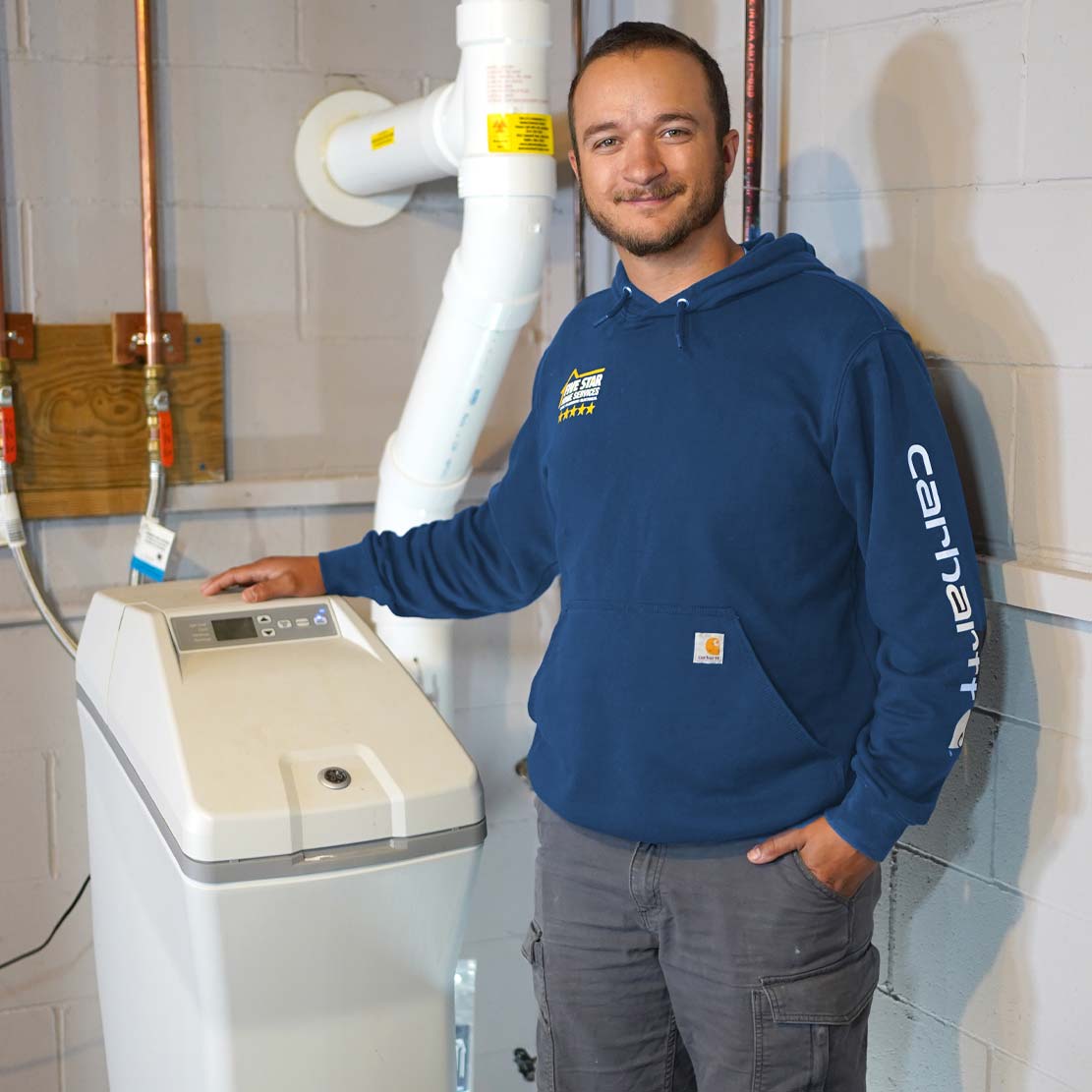 Plumber Standing Next to a Water Softener