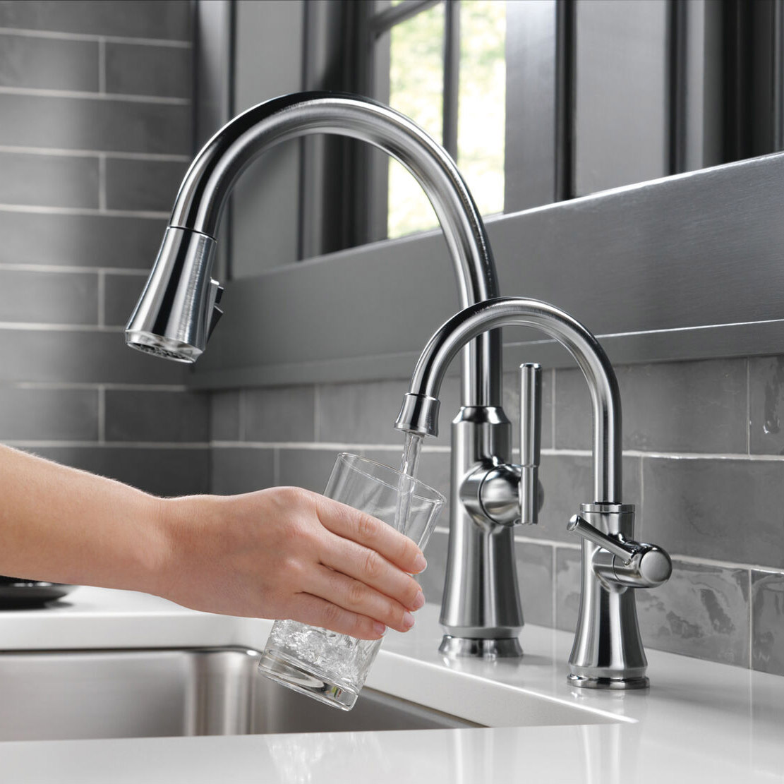 Hand with a Glass Getting water from A Faucet