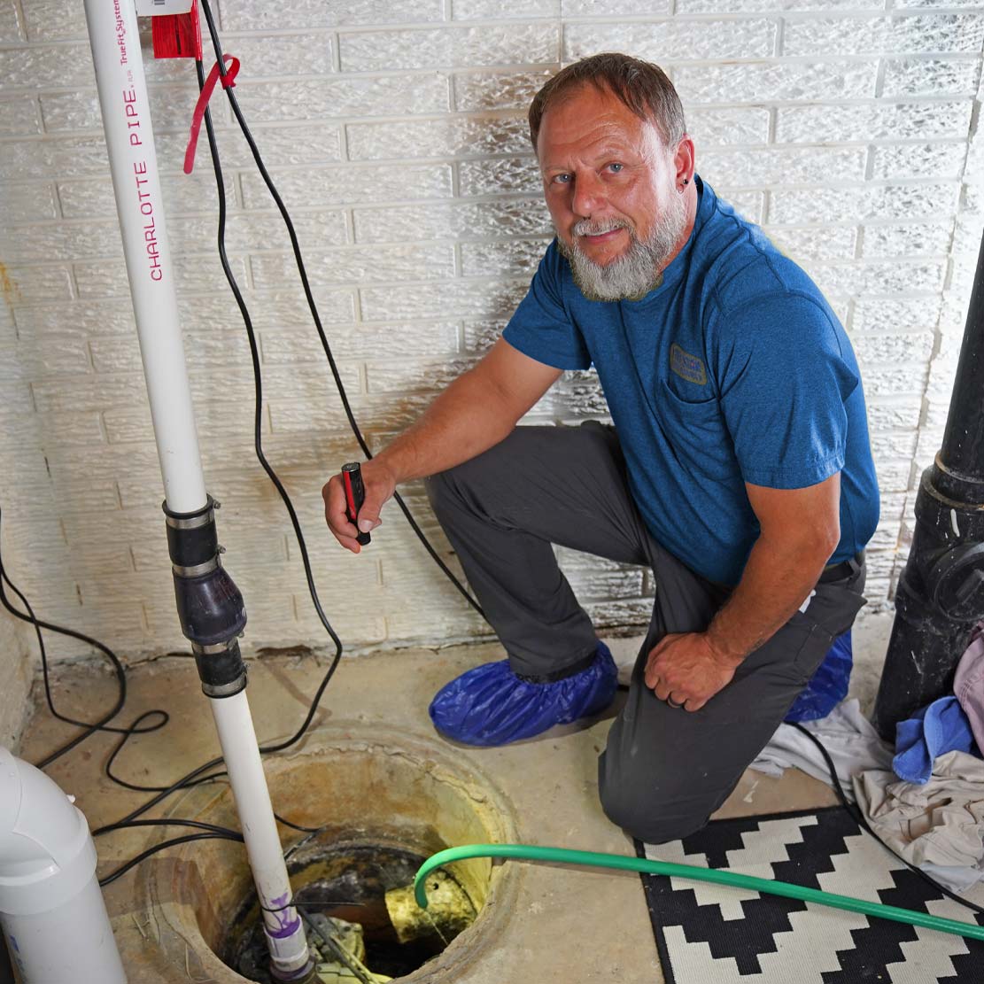 Plumber Fixing a Sump Pump