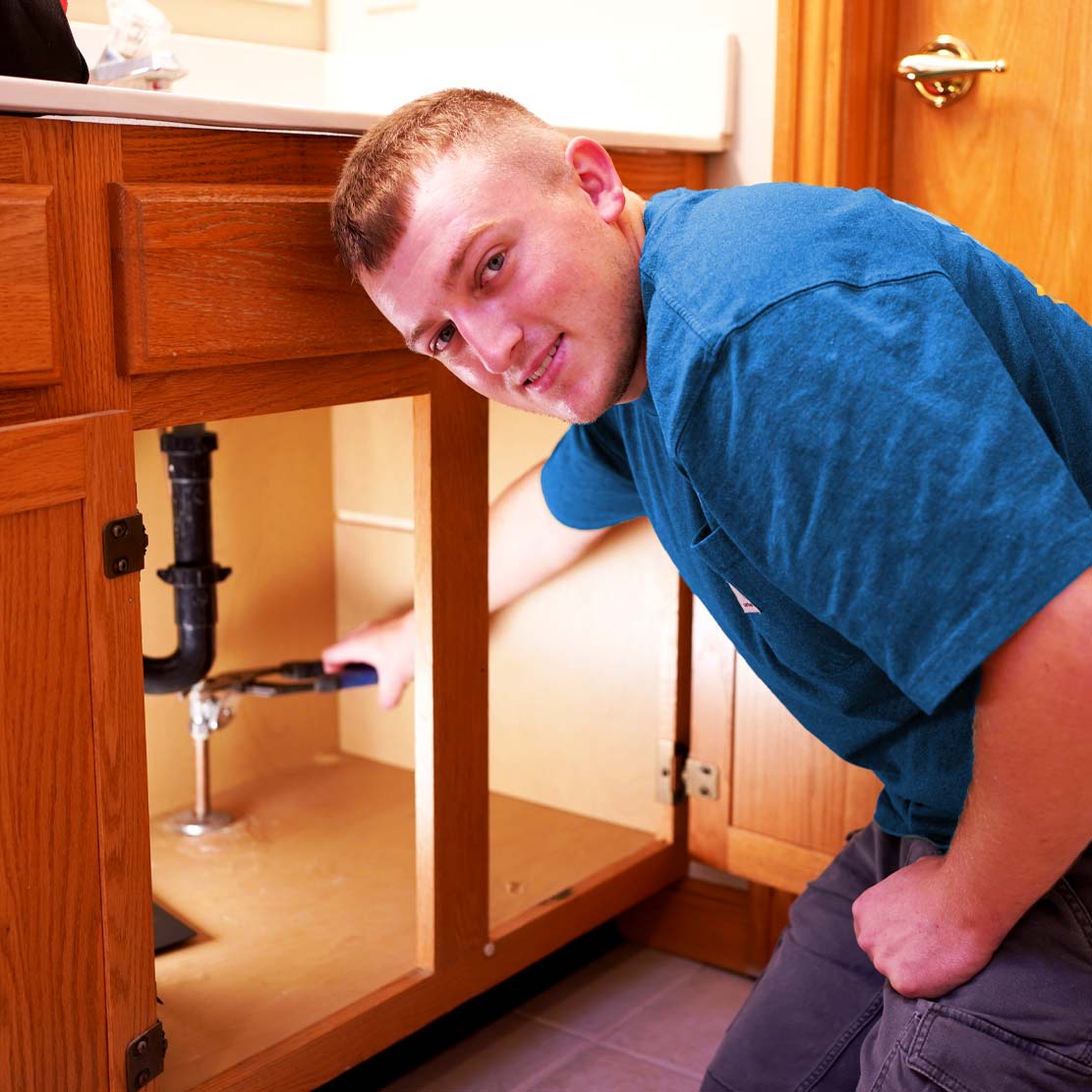 Plumber Fixing a Bathroom Sink